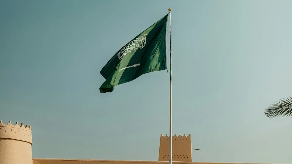 العلم السعودي أمام مبنى تراثي